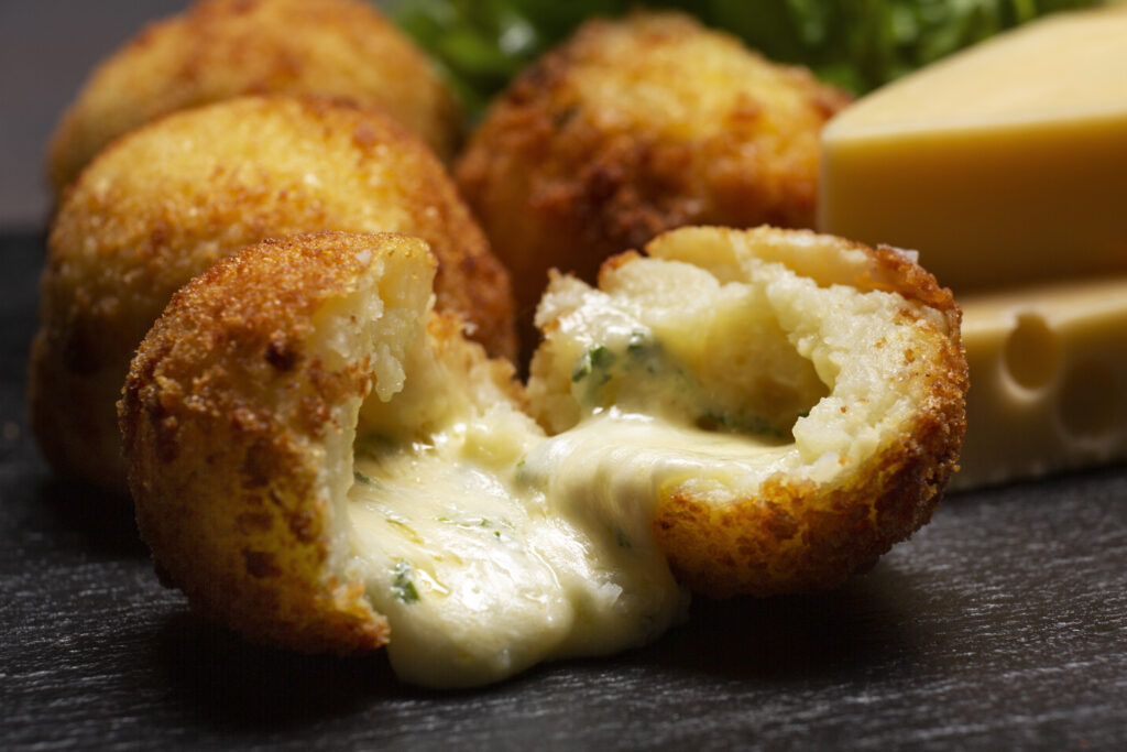 Crispy Supplì rice balls filled with mozzarella cheese and tomato sauce in Rome